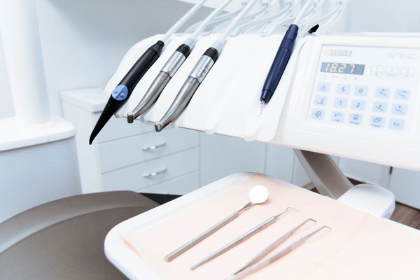 A set of dental instruments arranged on a tray