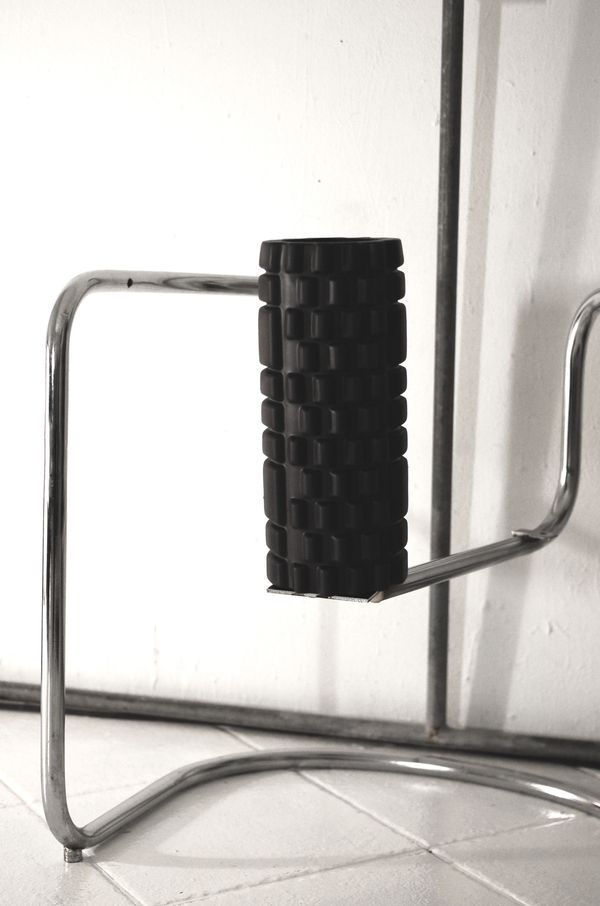 A foam roller on a metal stand prepared for use