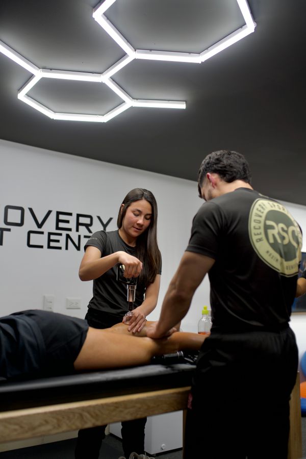 Physiotherapists performing a treatment with clinical equipment